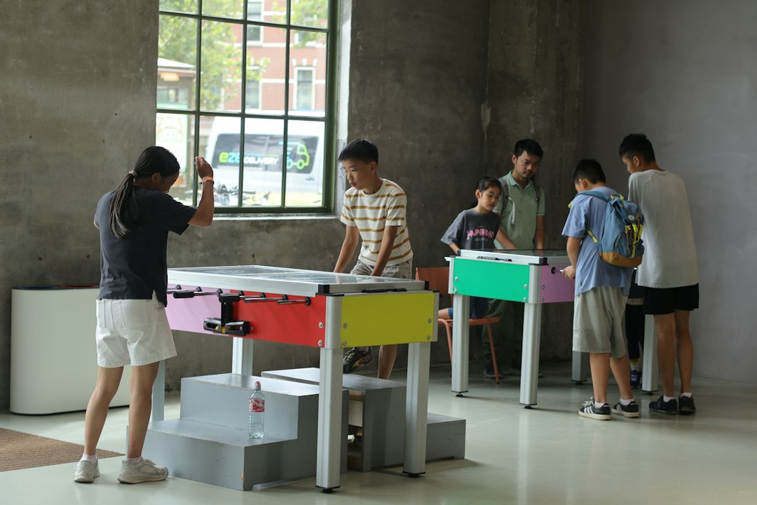 Illustrative stock photo of people taking part in indoor community activities; not the Sela centre in Netanya. Photo: Yanhao Fang / Unsplash.