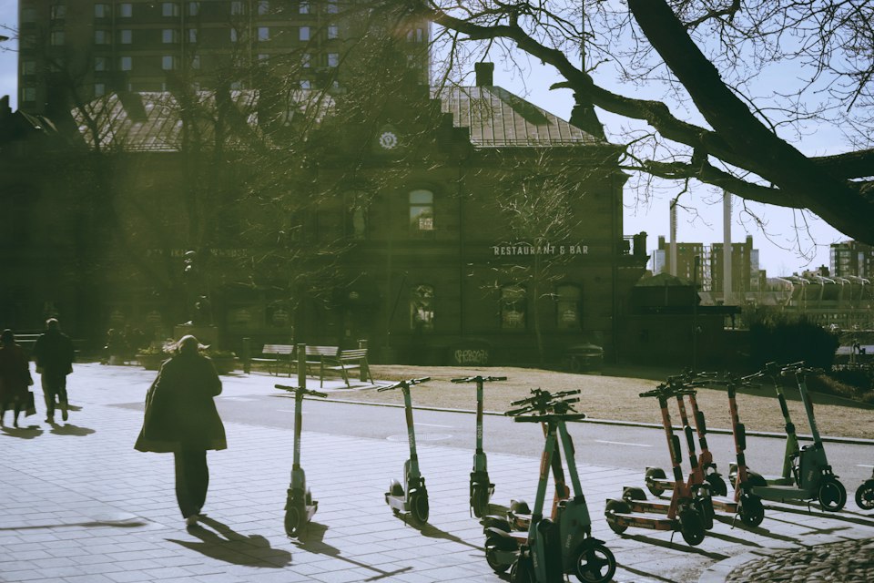 Illustrative electric scooter on a sidewalk