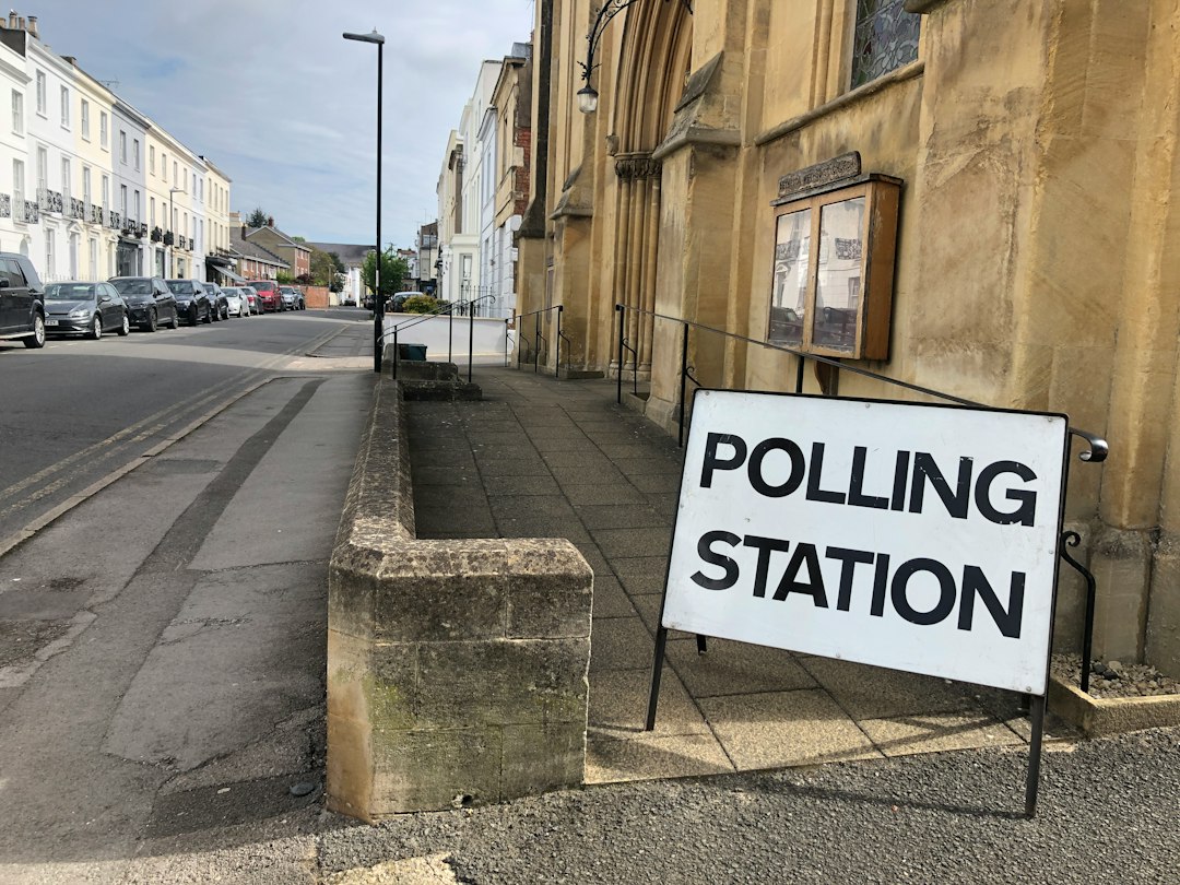 Polling station sign — illustrative stock photo, not the Netanya incident; Red Dot / Unsplash