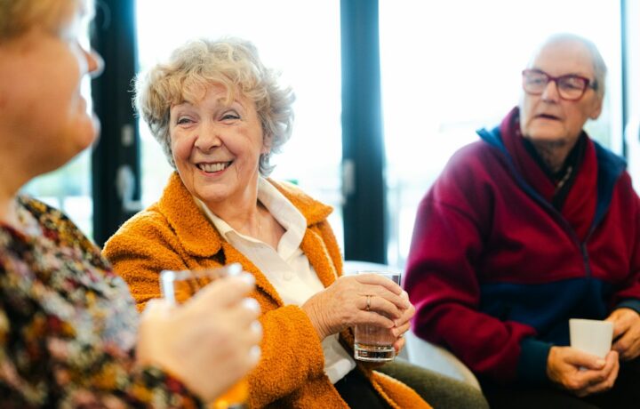 Illustrative stock photo of three senior adults talking at a community event; not a photograph of Netanya's 2026 Senior Citizens Month events. Photo: Centre for Ageing Better / Unsplash.