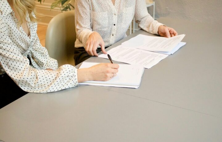 Illustration: a service consultation over documents; not a photograph of the Netanya event. Photo: Gabrielle Henderson / Unsplash.