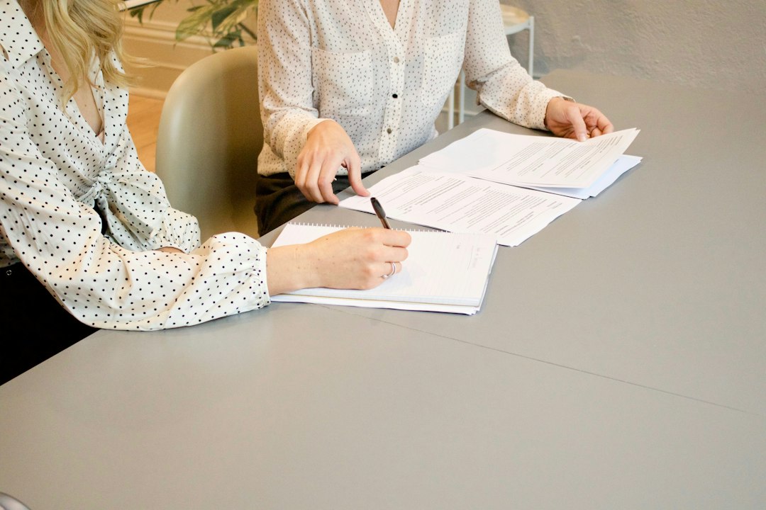 Illustration: a service consultation over documents; not a photograph of the Netanya event. Photo: Gabrielle Henderson / Unsplash.