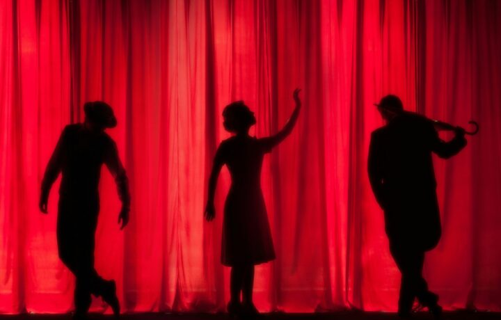 Illustration: performers on a theater stage, not a photograph of the announced Netanya show. Photo Kyle Head / Unsplash.